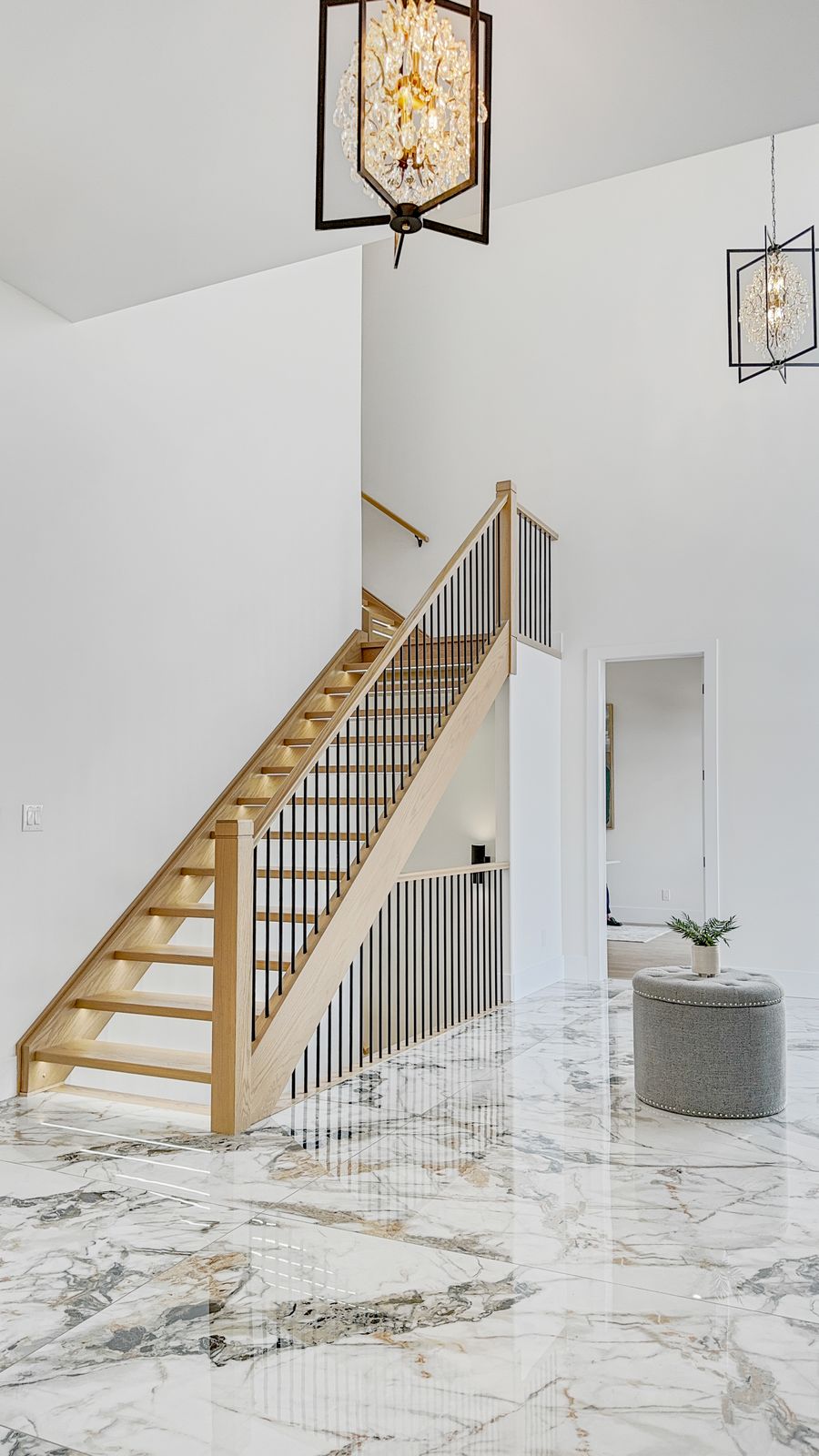 Feature staircase with glass railing in a completed Carnaby home