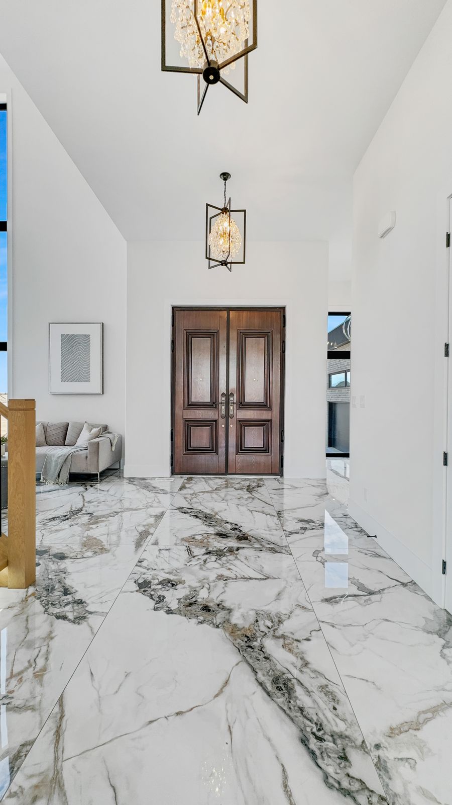 Finished foyer with marble-look tile in a completed Carnaby home