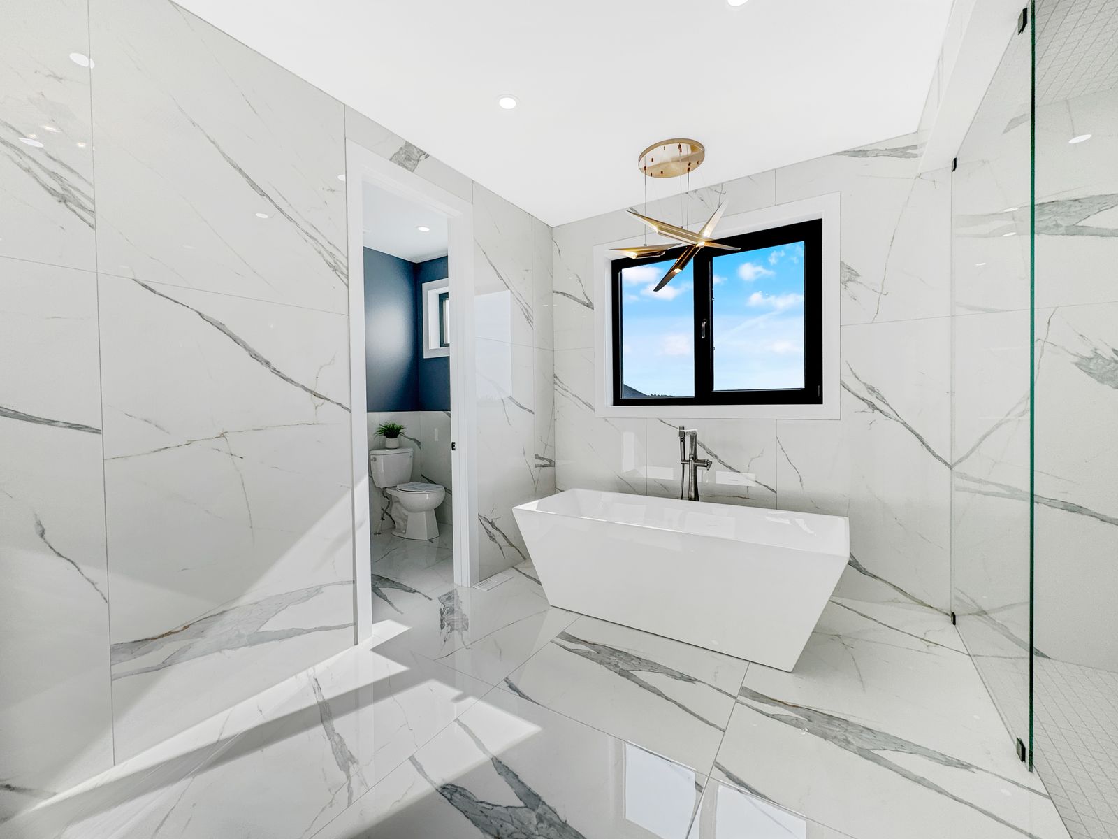 Ensuite with freestanding soaker tub in a completed Carnaby home
